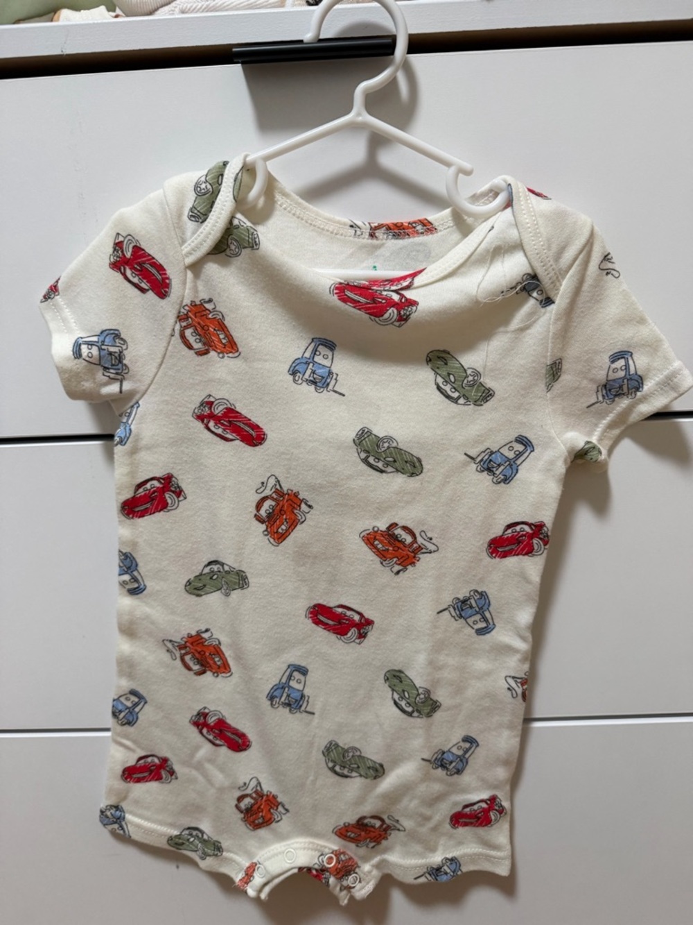 Disney Baby Cream Onesie with Red, Green, Blue, and Orange Car Print